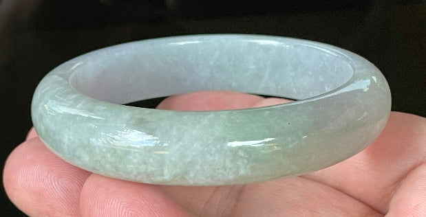 Close-up of fine crystalline texture and apple green hues on very icy lavender and white jadeite bangle