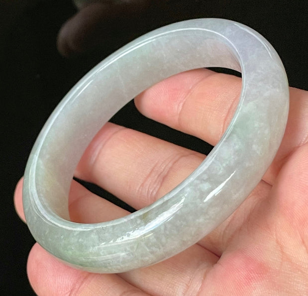 Close-up of fine crystalline texture and apple green hues on very icy lavender and white jadeite bangle