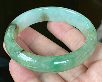 Close-up of fine crystalline texture and imperial green hues on icy bluish white jadeite bangle