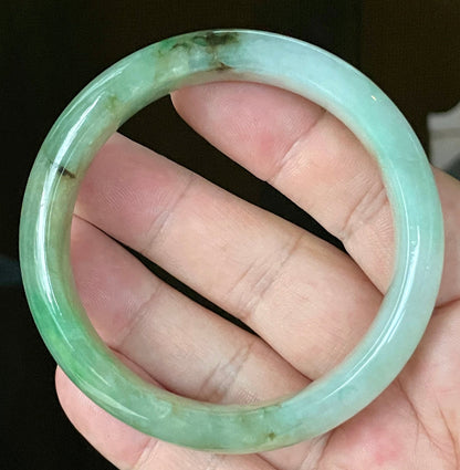 Close-up of fine crystalline texture and imperial green hues on icy bluish white jadeite bangle