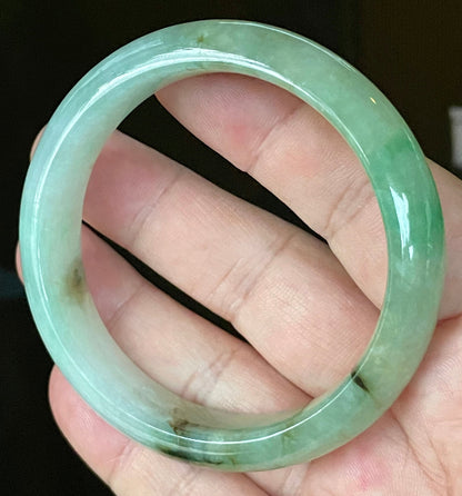 Close-up of fine crystalline texture and imperial green hues on icy bluish white jadeite bangle