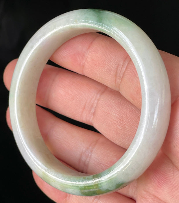 Close-up of fine crystalline texture and imperial green hues on icy milky white and lavender jadeite bangle