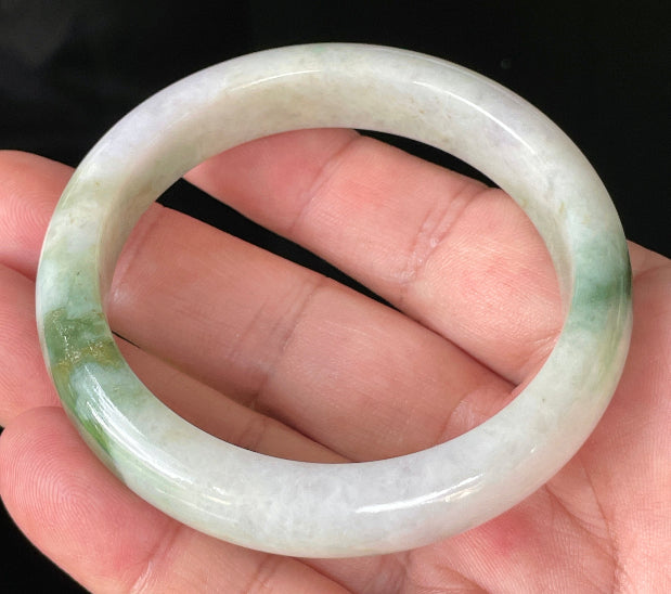 Close-up of fine crystalline texture and imperial green hues on icy milky white and lavender jadeite bangle