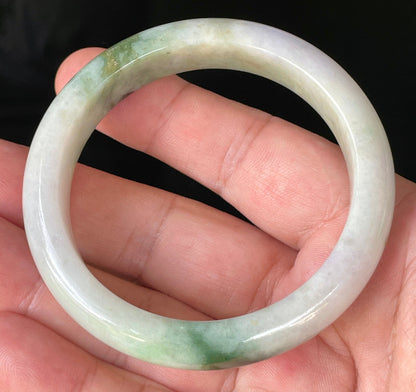 Close-up of fine crystalline texture and imperial green hues on icy milky white and lavender jadeite bangle
