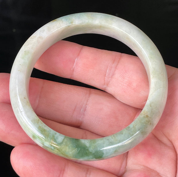 Close-up of fine crystalline texture and imperial green hues on icy milky white and lavender jadeite bangle