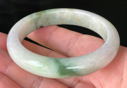 Close-up of fine crystalline texture and imperial green hues on icy milky white and lavender jadeite bangle