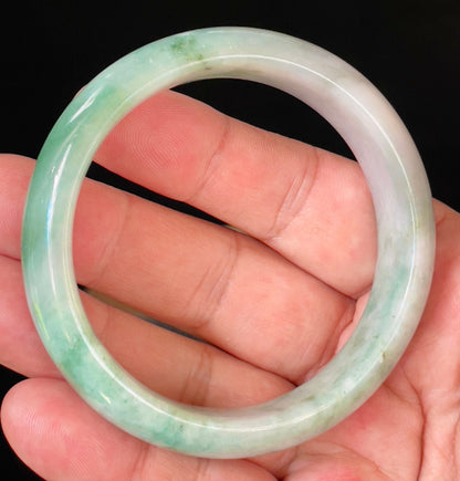 Close-up of fine crystalline texture and radiant imperial green hues on icy greyish white jadeite bangle