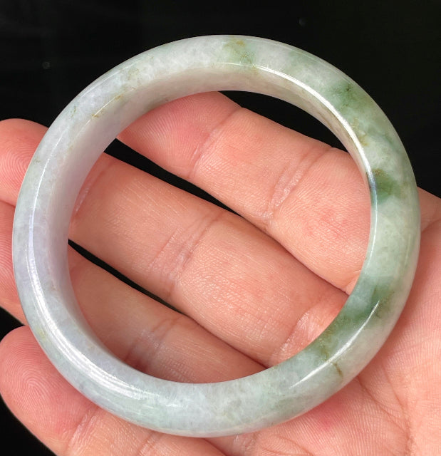 Close-up of fine crystalline texture and imperial green hues on icy white and lavender jadeite bangle