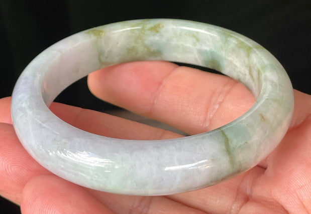Close-up of fine crystalline texture and imperial green hues on icy white and lavender jadeite bangle