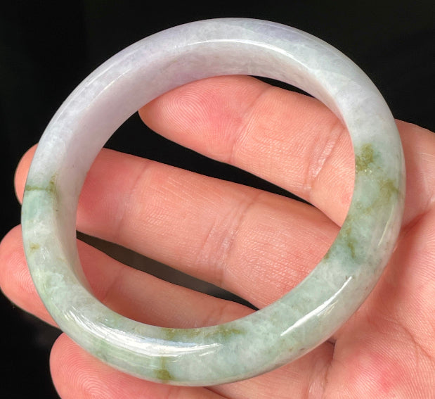 Close-up of fine crystalline texture and imperial green hues on icy white and lavender jadeite bangle