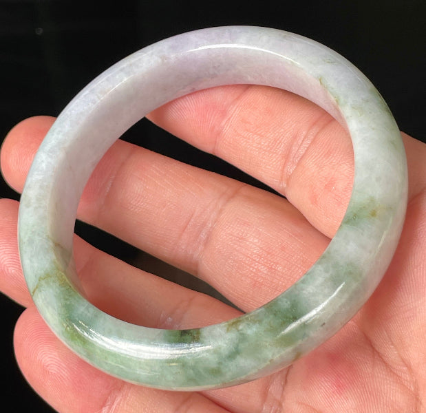 Close-up of fine crystalline texture and imperial green hues on icy white and lavender jadeite bangle
