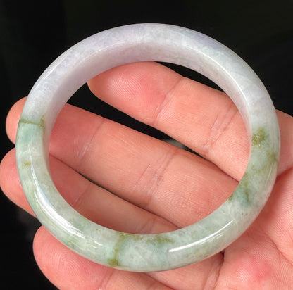 Close-up of fine crystalline texture and imperial green hues on icy white and lavender jadeite bangle