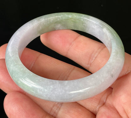 Close-up of fine crystalline texture and moss in the snow effect on icy light lavender and apple green jadeite bangle
