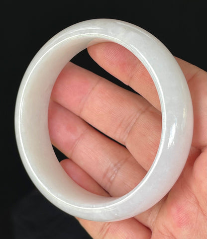 Close-up of fine crystalline texture and gentle honey tones on icy milky white jadeite bangle