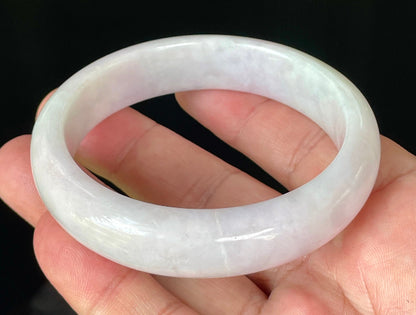 Close-up of fine crystalline texture and gentle light lavender hues on icy milky white jadeite bangle