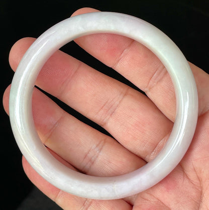 Close-up of fine crystalline texture and gentle light lavender hues on icy milky white jadeite bangle