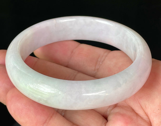 Close-up of fine crystalline texture and gentle light lavender hues on icy milky white jadeite bangle