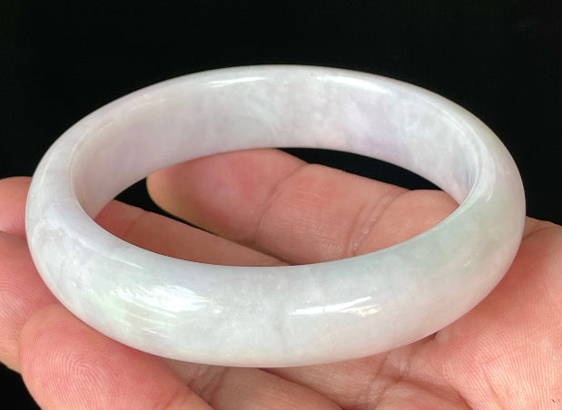 Close-up of fine crystalline texture and gentle light lavender hues on icy milky white jadeite bangle