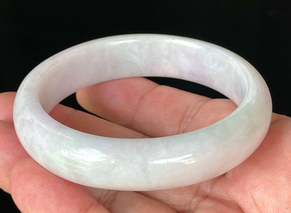 Close-up of fine crystalline texture and gentle light lavender hues on icy milky white jadeite bangle