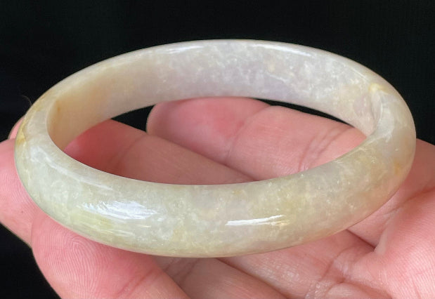 Close-up of fine crystalline texture and delicate light lavender hues on icy yellow and honey jadeite bangle