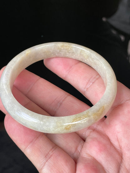 Close-up of fine crystalline texture and delicate light lavender hues on icy yellow and honey jadeite bangle