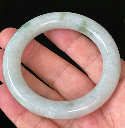 Close-up of fine crystalline texture and imperial green hues on icy milky white and grey jadeite bangle