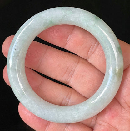 Close-up of fine crystalline texture and imperial green hues on icy milky white and grey jadeite bangle