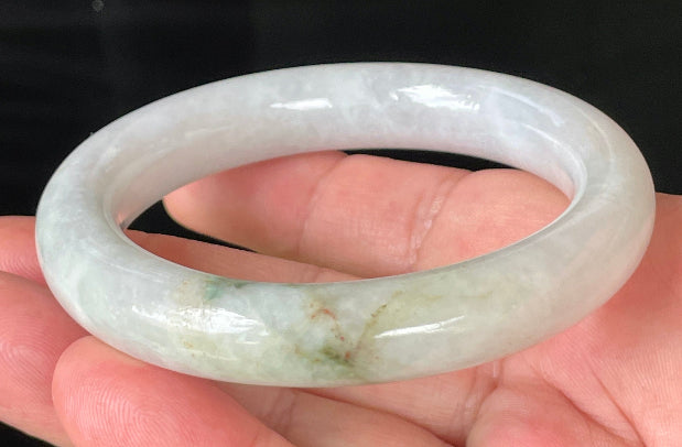 Close-up of fine crystalline texture and imperial green veins on icy milky white jadeite bangle