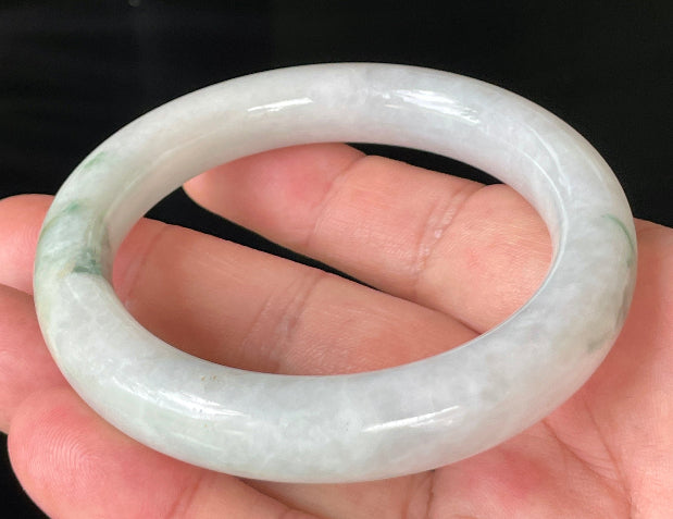 Close-up of fine crystalline texture and imperial green veins on icy milky white jadeite bangle