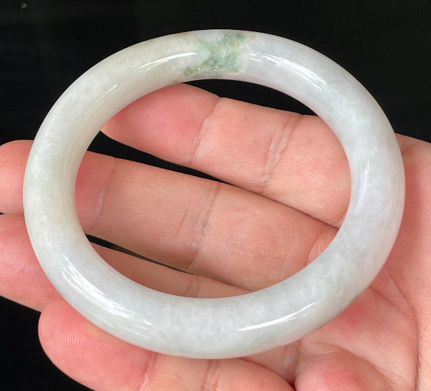 Close-up of fine crystalline texture and imperial green veins on icy milky white jadeite bangle
