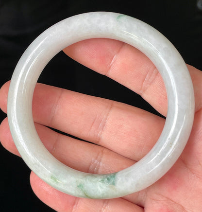 Close-up of fine crystalline texture and imperial green veins on icy milky white jadeite bangle