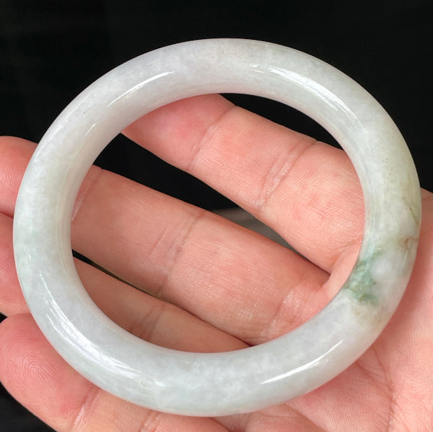 Close-up of fine crystalline texture and imperial green veins on icy milky white jadeite bangle