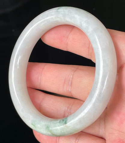 Close-up of fine crystalline texture and imperial green veins on icy milky white jadeite bangle