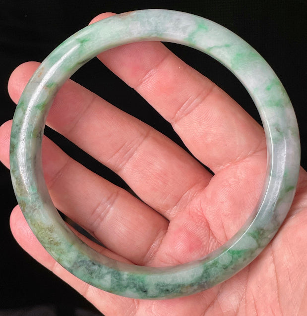 Close-up of fine crystalline texture and floral moss in the snow pattern on icy imperial green jadeite bangle