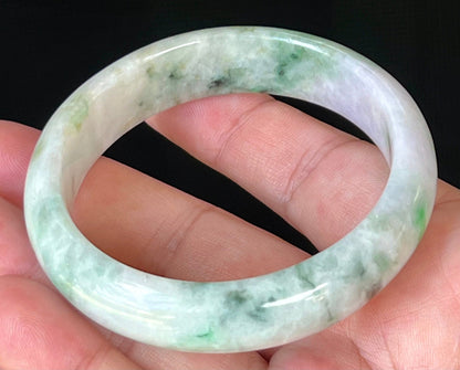 Close-up of fine crystalline texture and imperial green patterns on icy white and lavender jadeite bangle