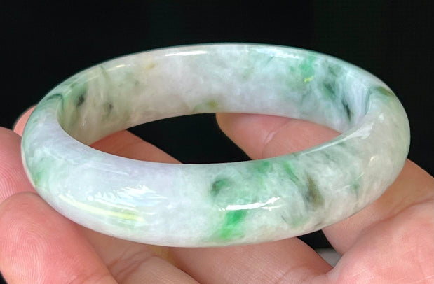 Close-up of fine crystalline texture and imperial green patterns on icy white and lavender jadeite bangle