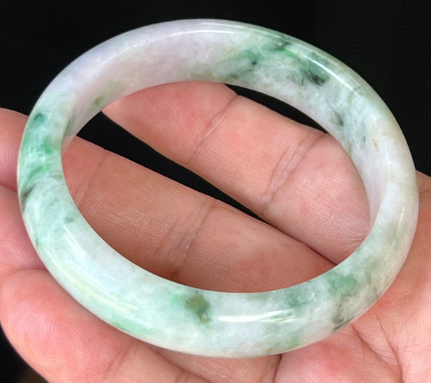 Close-up of fine crystalline texture and imperial green patterns on icy white and lavender jadeite bangle