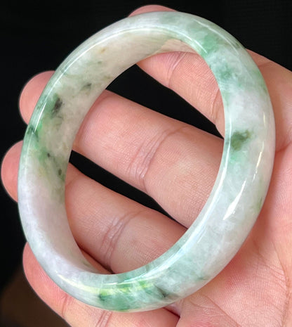 Close-up of fine crystalline texture and imperial green patterns on icy white and lavender jadeite bangle