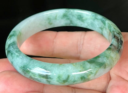 Close-up of fine crystalline texture and imperial green hues on icy bluish white jadeite bangle
