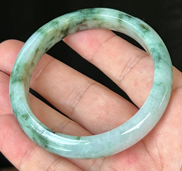 Close-up of fine crystalline texture and imperial green hues on icy bluish white jadeite bangle