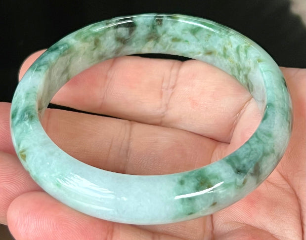 Close-up of fine crystalline texture and imperial green hues on icy bluish white jadeite bangle