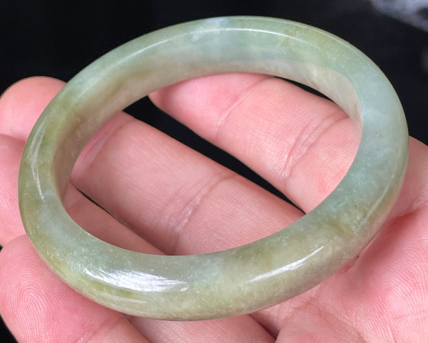 Close-up of fine crystalline texture and soothing green hues on icy milky white jadeite bangle