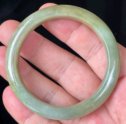 Close-up of fine crystalline texture and soothing green hues on icy milky white jadeite bangle