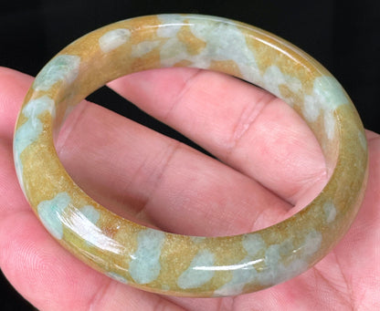 Close-up of fine crystalline texture and warm golden brown hues on icy honey jadeite bangle