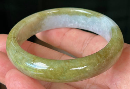 Close-up of fine crystalline texture and honey hues on icy apple green jadeite bangle