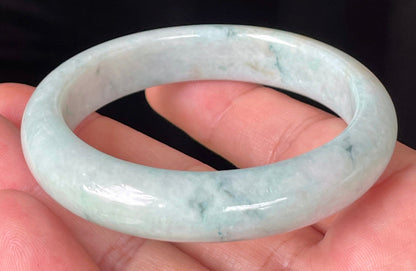 Close-up of fine crystalline texture and soothing green hues on icy milky white jadeite bangle