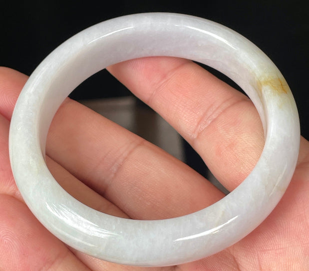 Close-up of fine crystalline texture and delicate honey hues on icy light lavender jadeite bangle