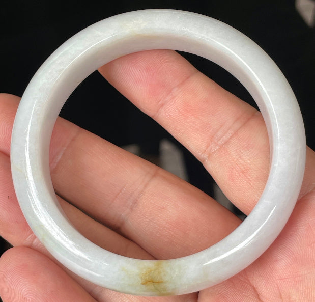 Close-up of fine crystalline texture and delicate honey hues on icy light lavender jadeite bangle