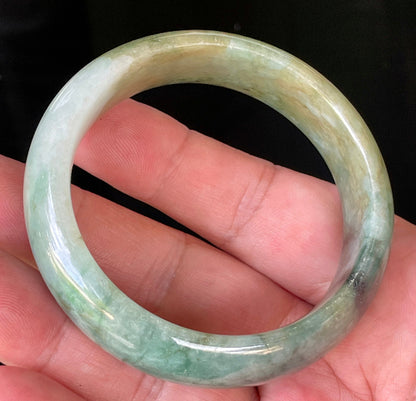 Close-up of fine crystalline texture and natural jade veins on icy bluish apple green jadeite bangle