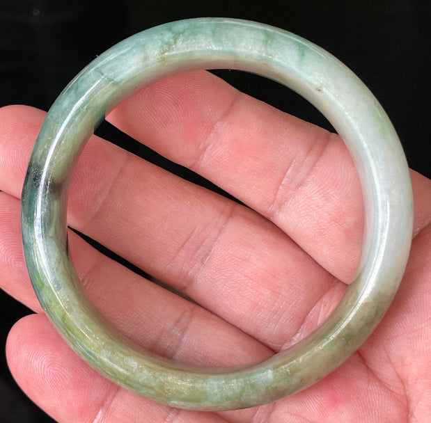 Close-up of fine crystalline texture and natural jade veins on icy bluish apple green jadeite bangle
